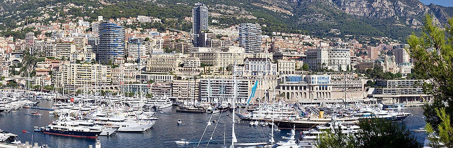 Monte Carlo and the Port d’Hercule, from St. Dévote church, left on the bottom, to the Casino terraces, in occasion of the Monaco Yacht Show. A gay patchwork of various architectonic styles and of underway works, such as those of the future seat of the Monaco Yacht Club, right on the bottom.