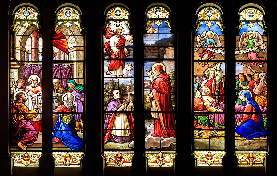 Monte Carlo: stained glass windows in the apse of Saint Charles church showing the Presentation of Jesus at the Temple of Jerusalem, the offering of the church to Saint Charles by Msgr. Thevret, and the demise of Saint Joseph.